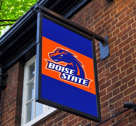 Digital sign with the Boise State logo on a red brick wall