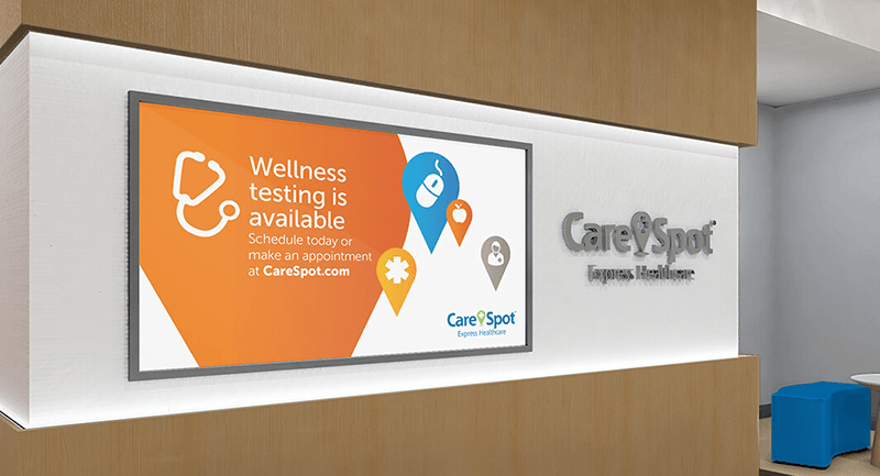 Digital signage TV with text saying "Wellness testing is available"