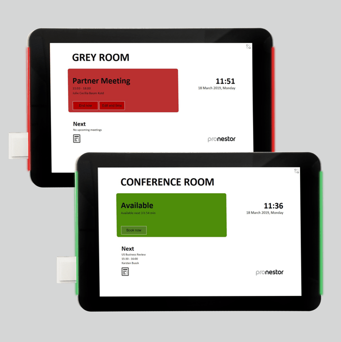 Two IAdea tablets displaying corporate meeting room information on a wall