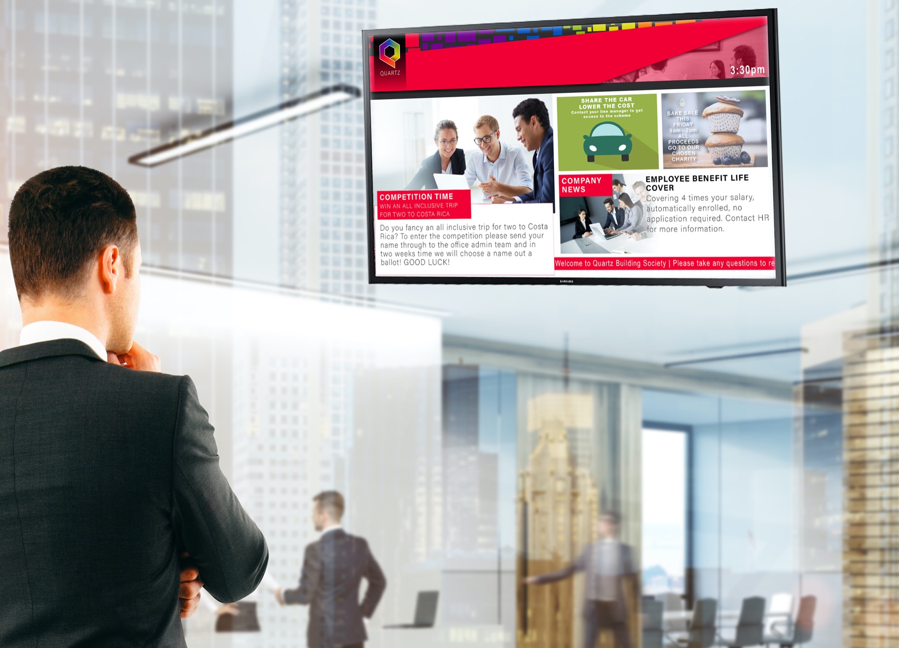 man in suit looking digital signage tv mounted on a wall in a lobby room